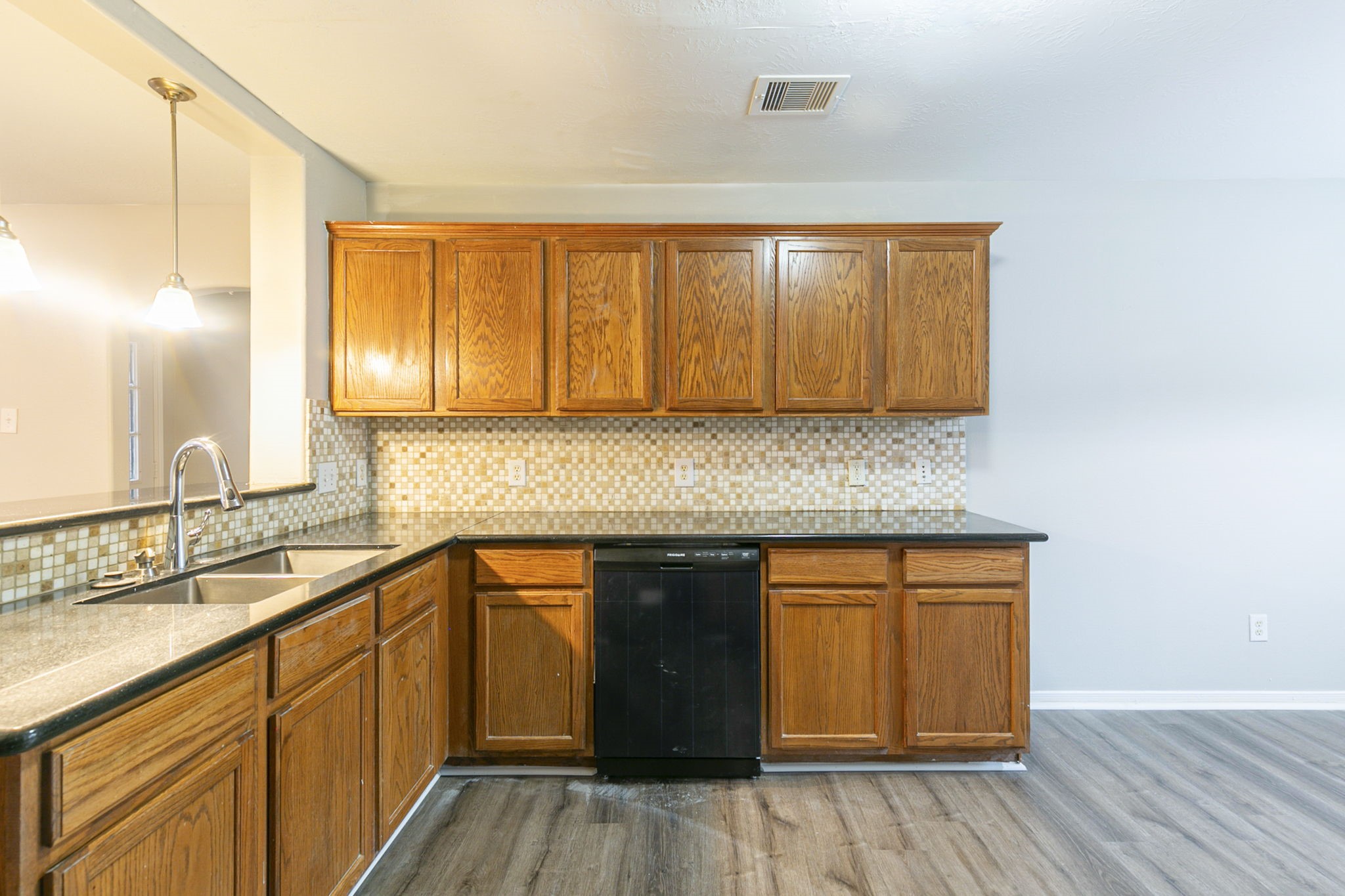 5601 Savannah Woods Lane Rosharon, TX 77583 - Photo 14 of 43 a kitchen with stainless steel appliances granite countertop wooden cabinets a sink and dishwasher