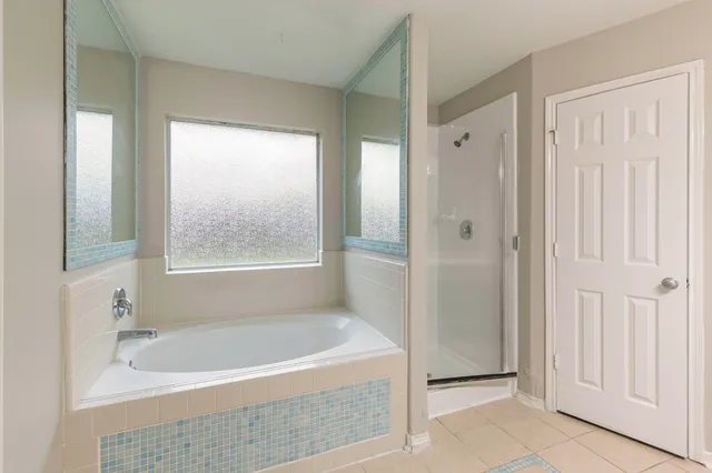 a bath tub sitting in a bathroom next to a window