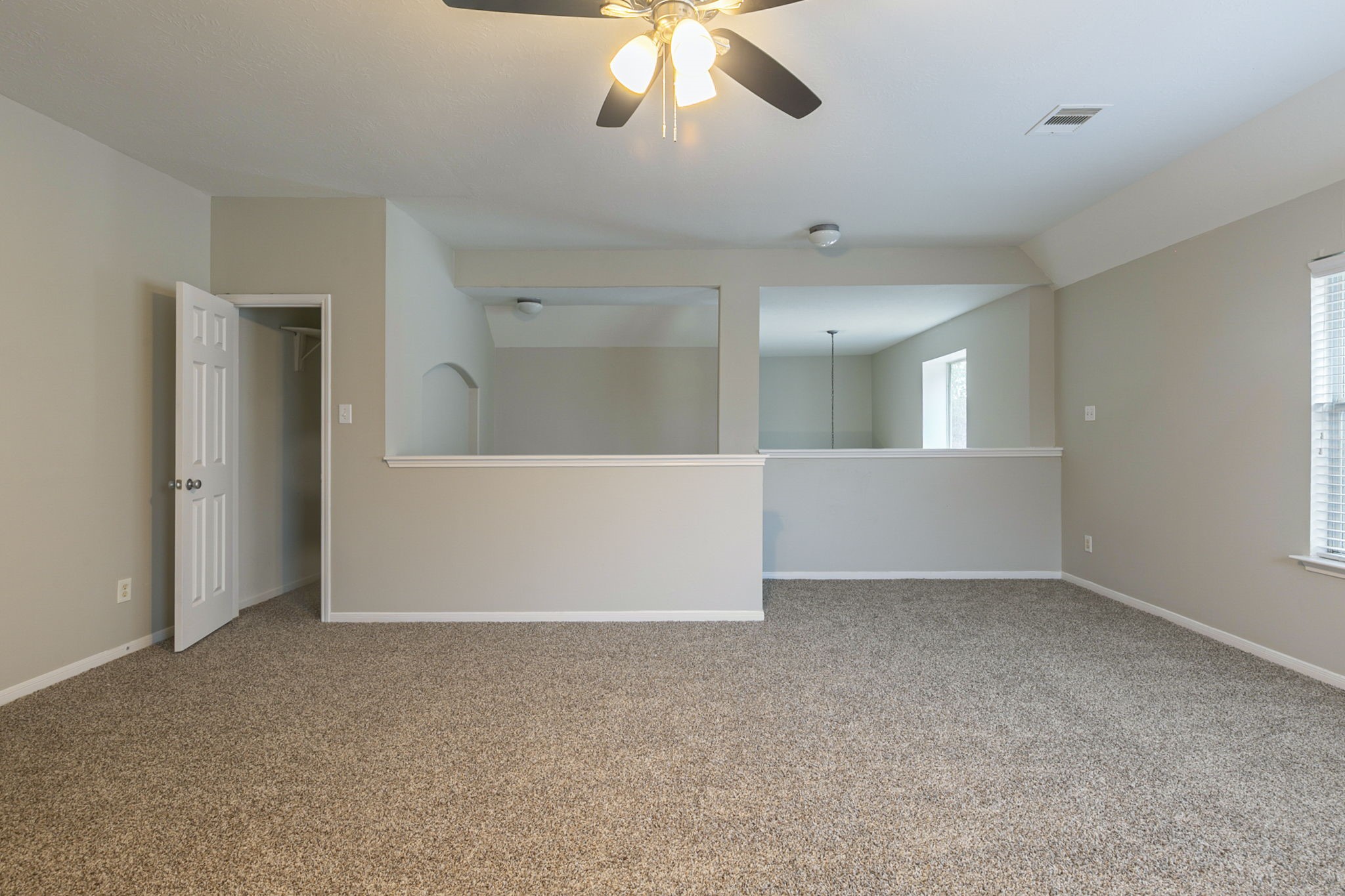 5601 Savannah Woods Lane Rosharon, TX 77583 - Photo 27 of 43 an empty room with chandelier fan and windows