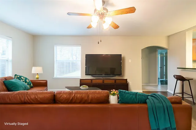 a living room with furniture and a flat screen tv