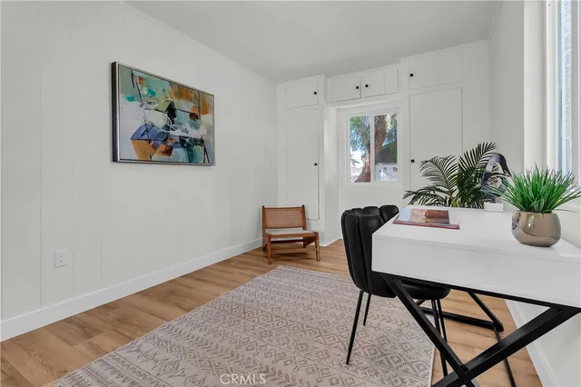 a bedroom with a bed and a lamp on dresser