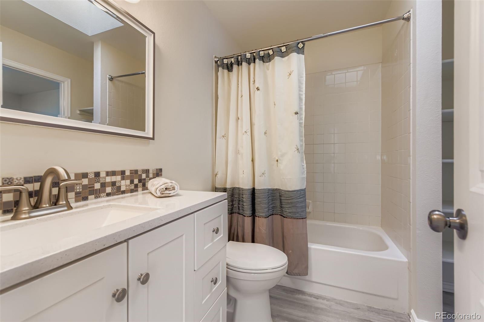 9510 Joyce Lane Highlands Ranch, CO 80126 - Photo 11 of 23 a bathroom with a sink a toilet and a bathtub