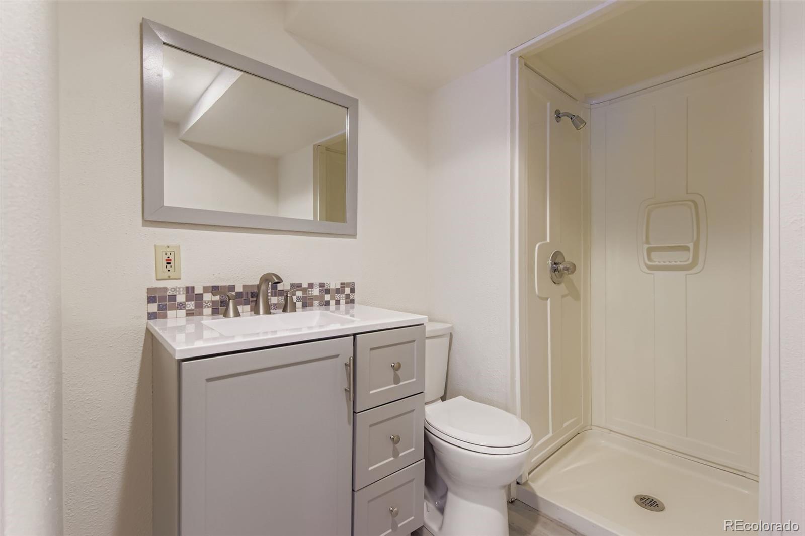 9510 Joyce Lane Highlands Ranch, CO 80126 - Photo 16 of 23 a bathroom with a sink toilet and shower