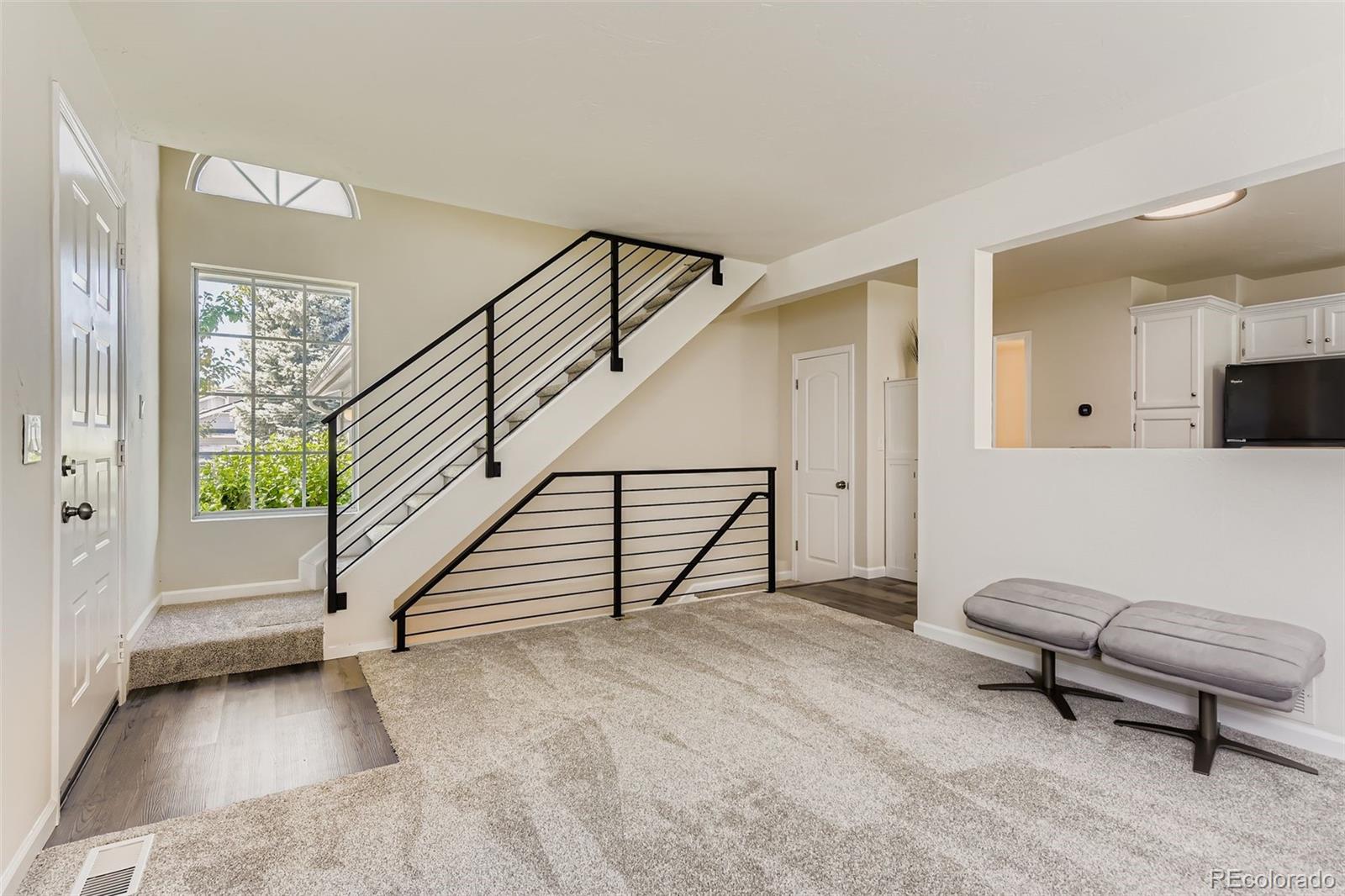 9510 Joyce Lane Highlands Ranch, CO 80126 - Photo 2 of 23 a view of livingroom with furniture and stairs