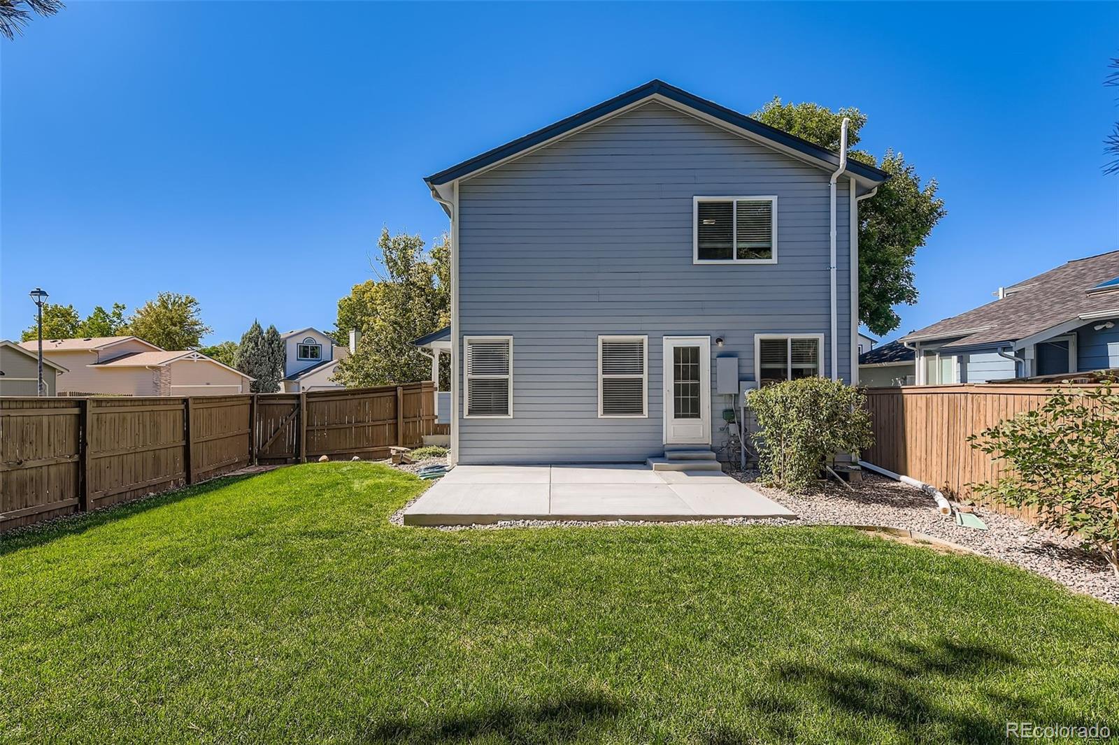 9510 Joyce Lane Highlands Ranch, CO 80126 - Photo 22 of 23 a front view of a house with a yard