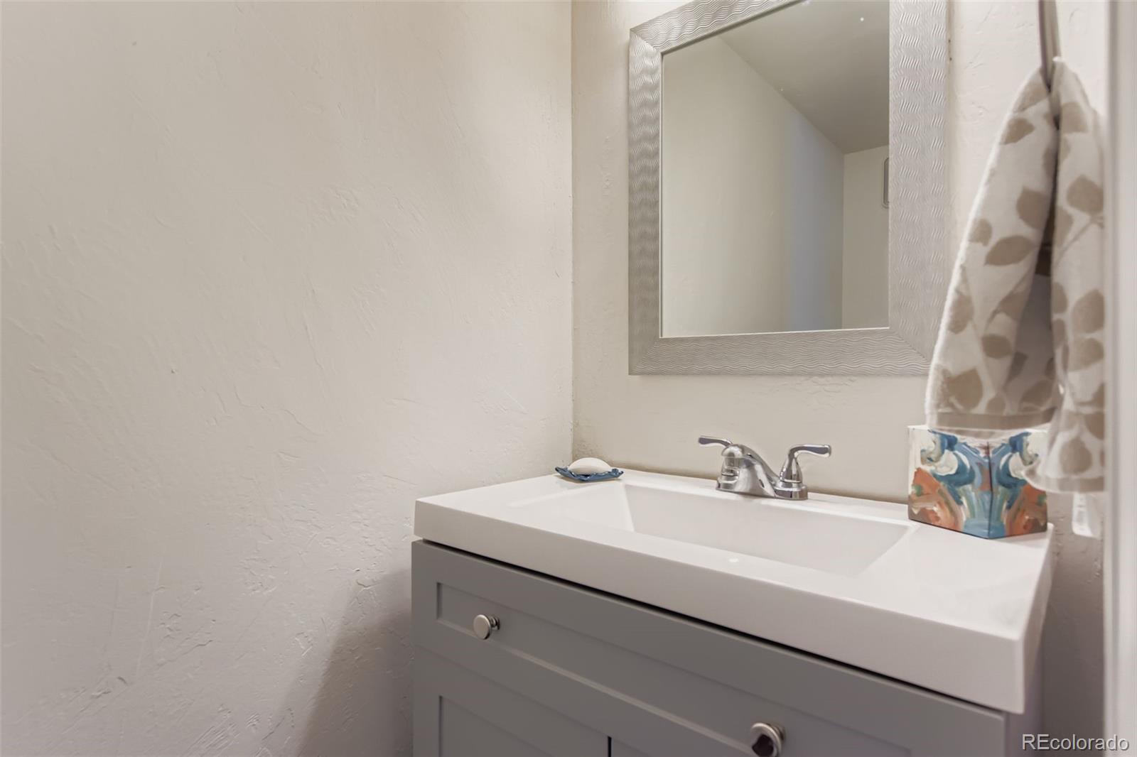 9510 Joyce Lane Highlands Ranch, CO 80126 - Photo 8 of 23 a bathroom with a sink and a mirror