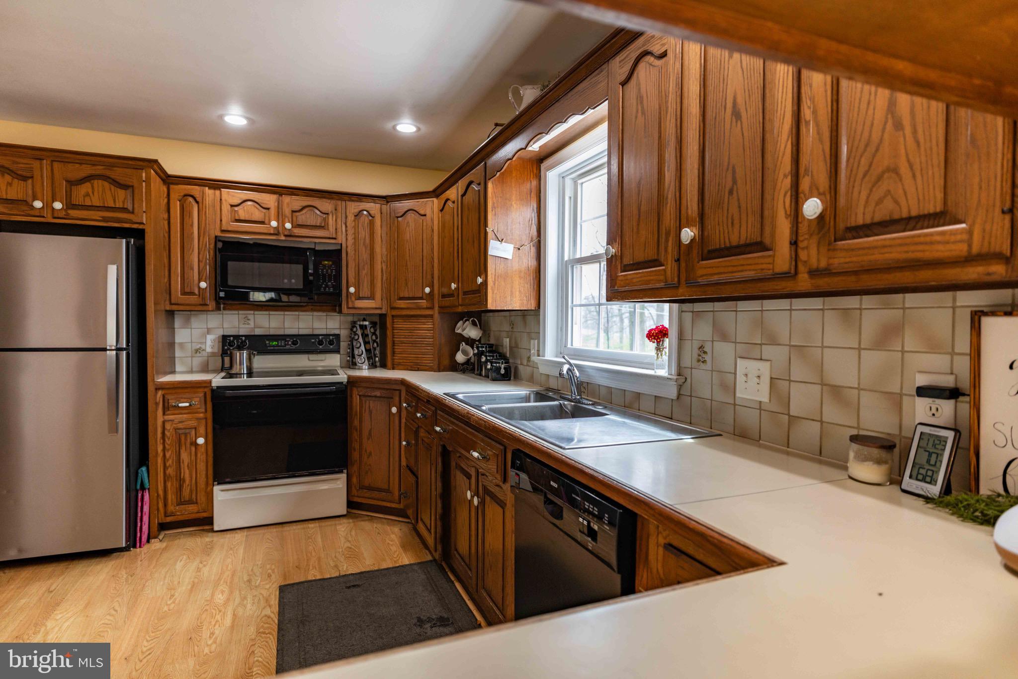 339 Churchtown Road Narvon, PA 17555 - Photo 106 of 150 a kitchen with stainless steel appliances granite countertop a refrigerator a sink and a stove