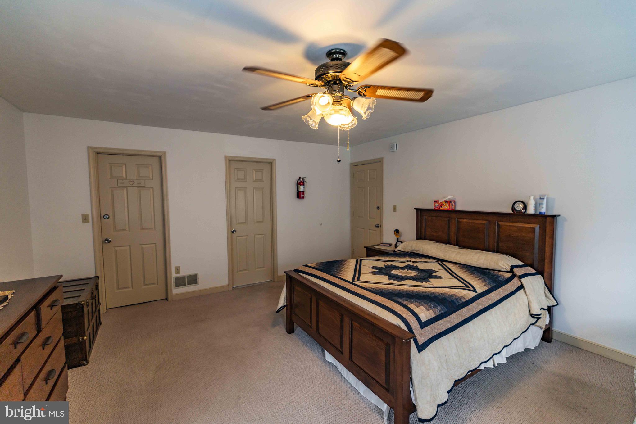 339 Churchtown Road Narvon, PA 17555 - Photo 125 of 150 a bed room with a bed and a chandelier