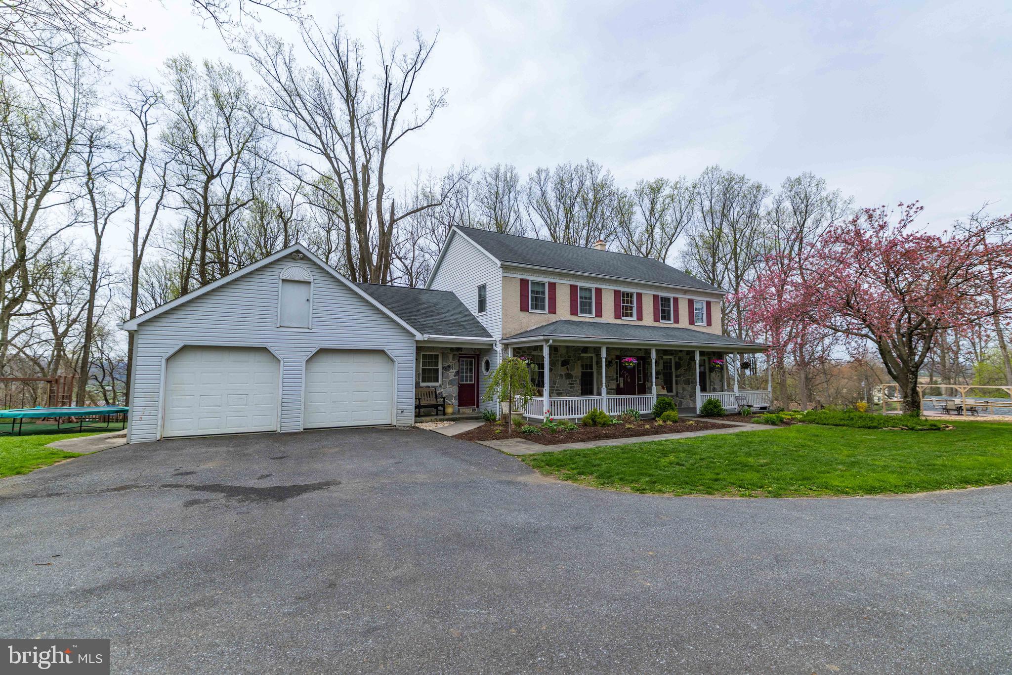 339 Churchtown Road Narvon, PA 17555 - Photo 78 of 150 a view of a white house next to a yard with trees and plants
