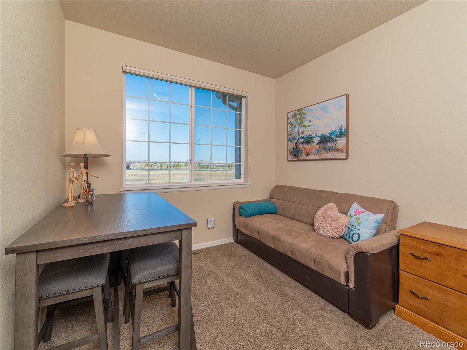 5025 Eagan Circle Longmont, CO 80503 - Photo 16 of 40 a living room with furniture and a window