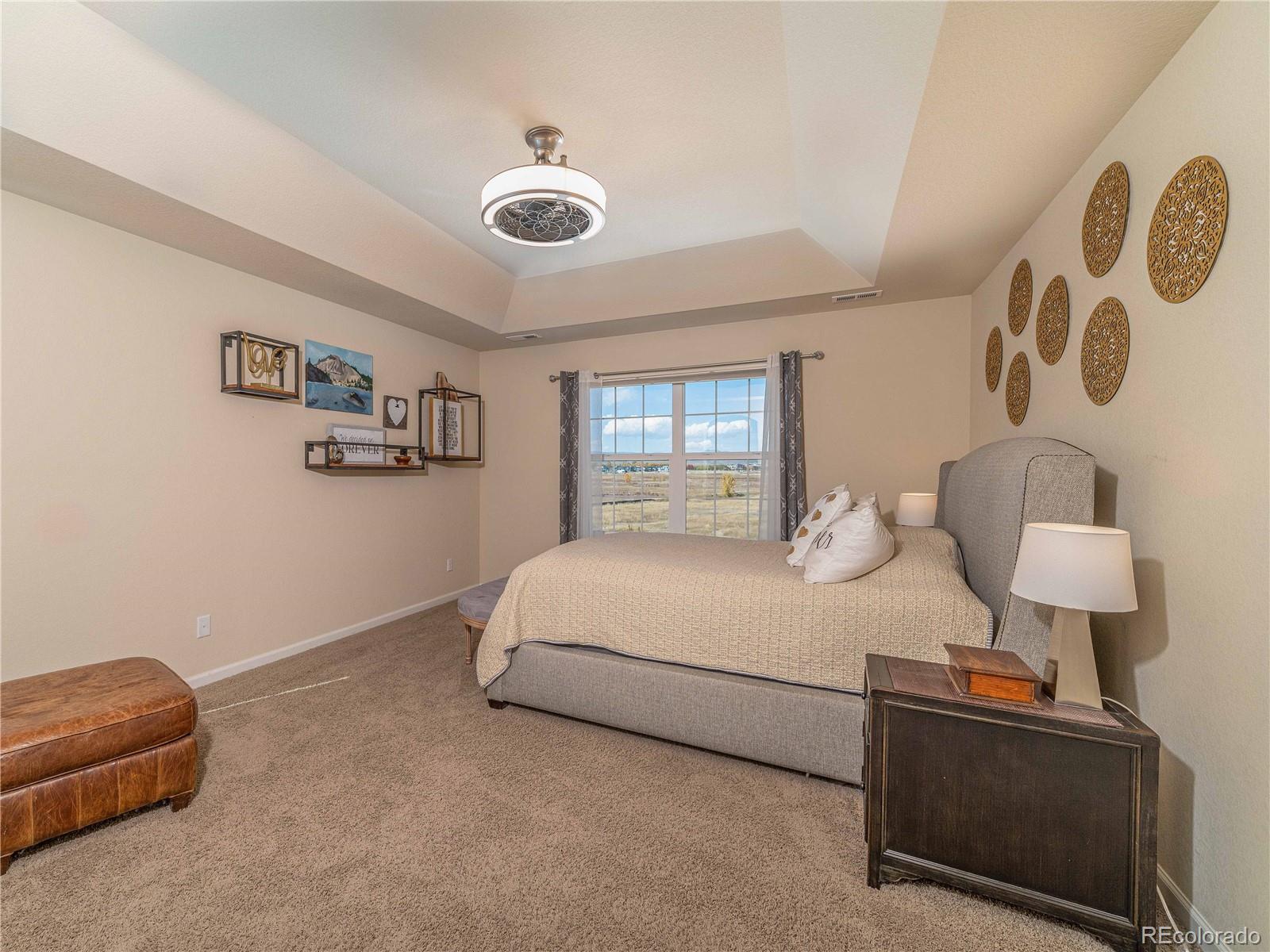 5025 Eagan Circle Longmont, CO 80503 - Photo 17 of 40 a bedroom with a bed and a lamp on dresser