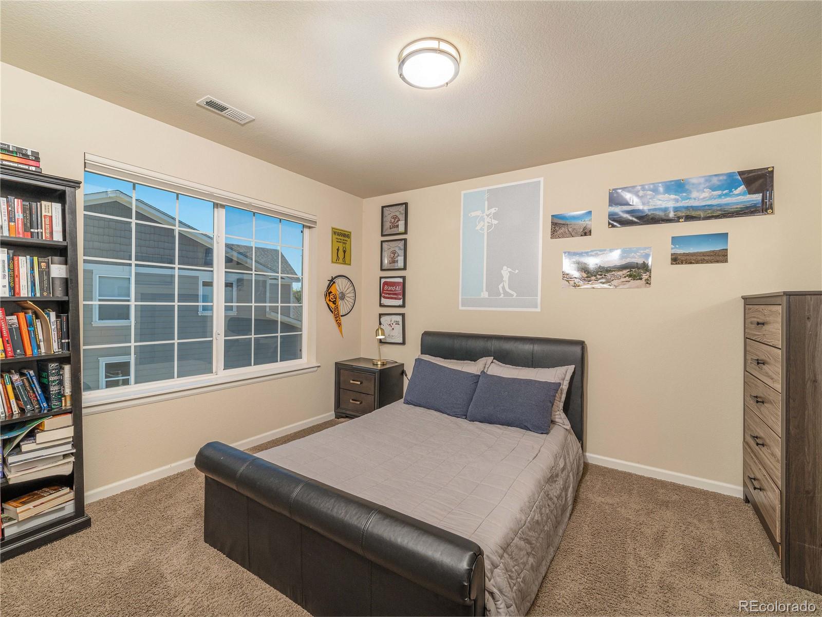 5025 Eagan Circle Longmont, CO 80503 - Photo 23 of 40 a bedroom with a bed and a large window