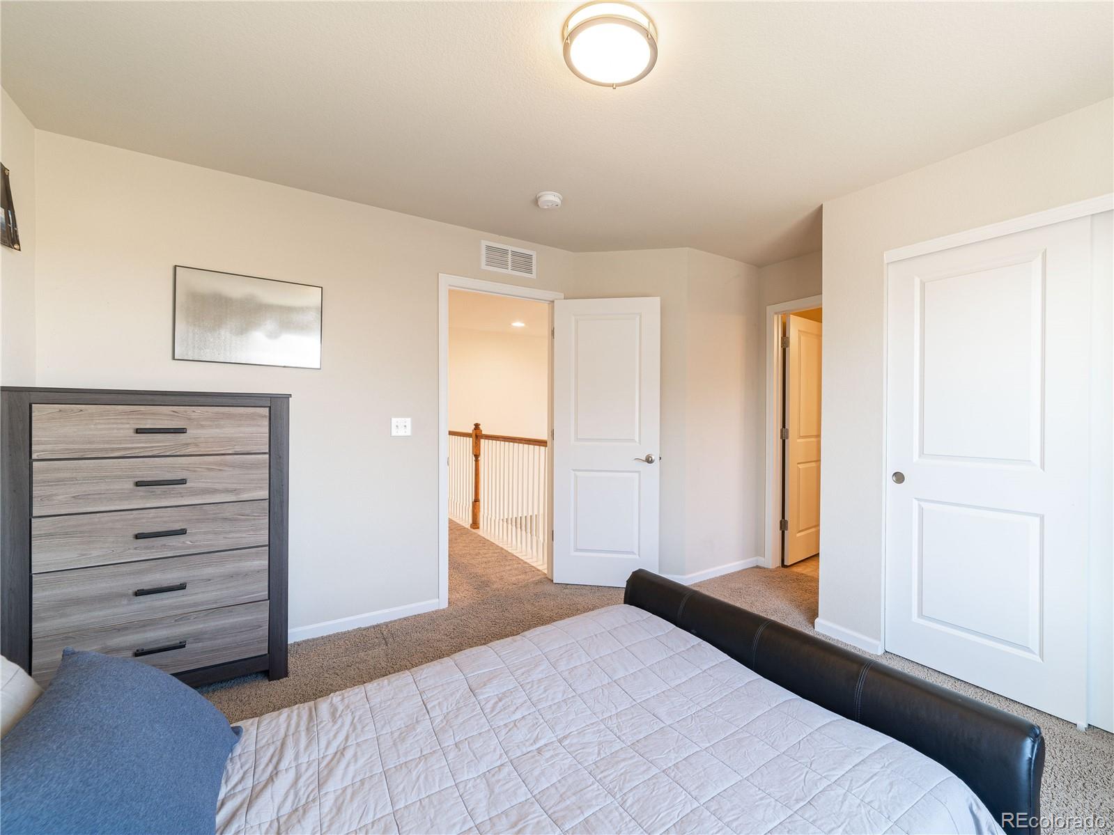 5025 Eagan Circle Longmont, CO 80503 - Photo 24 of 40 a bedroom with a bed and a dresser