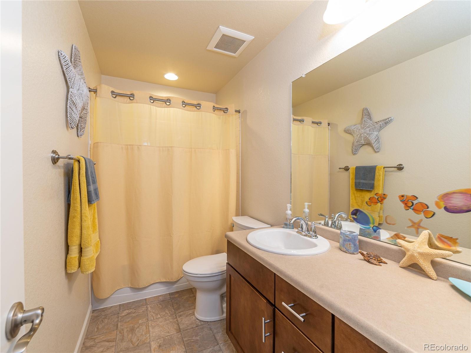 5025 Eagan Circle Longmont, CO 80503 - Photo 28 of 40 a bathroom with a double vanity sink mirror and toilet