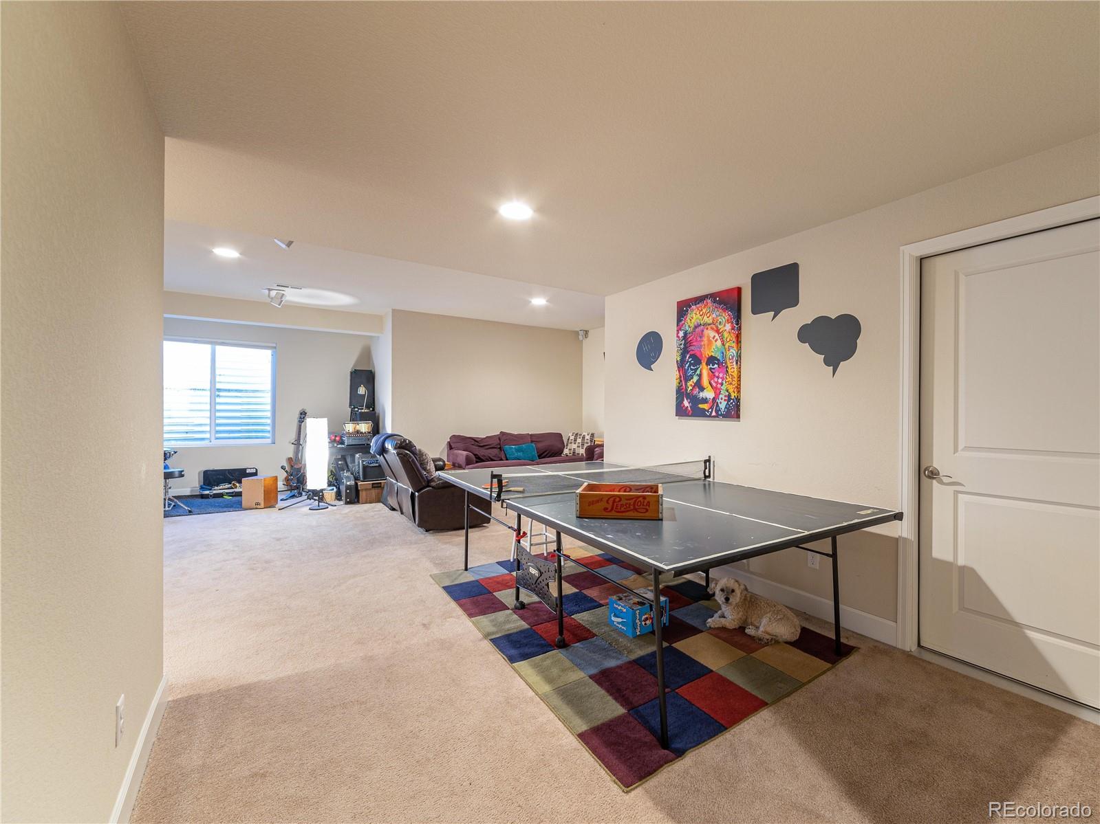 5025 Eagan Circle Longmont, CO 80503 - Photo 30 of 40 a living room with furniture a rug and kitchen view