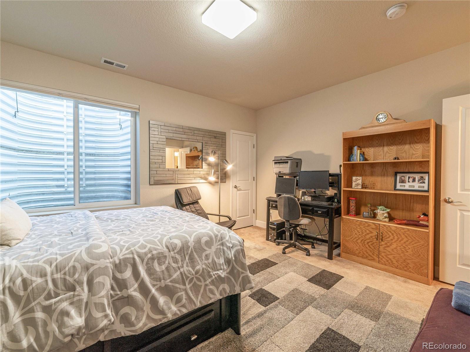 5025 Eagan Circle Longmont, CO 80503 - Photo 32 of 40 a bedroom with a bed and furniture