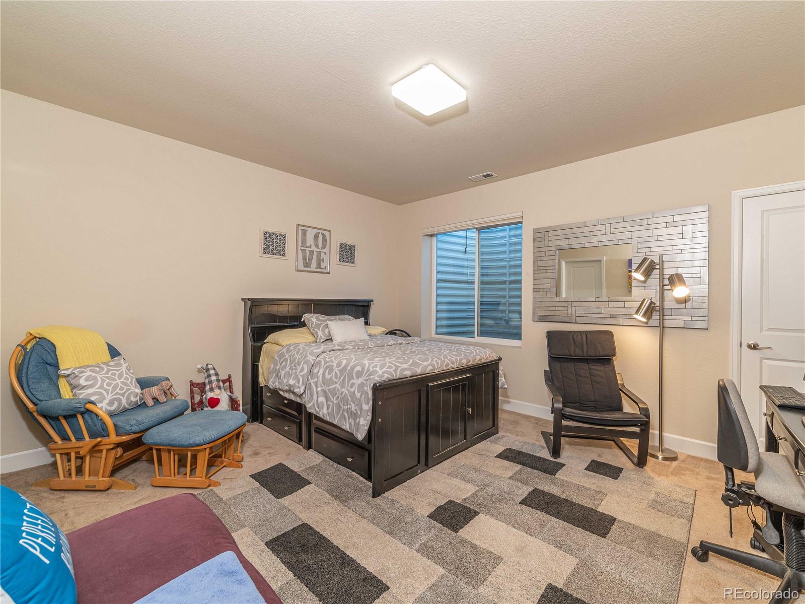 5025 Eagan Circle Longmont, CO 80503 - Photo 33 of 40 a bedroom with a bed and a workspace