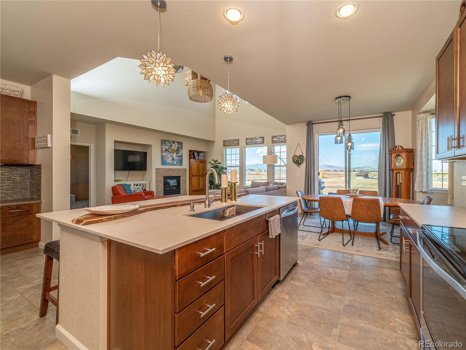5025 Eagan Circle Longmont, CO 80503 - Photo 5 of 40 a large white kitchen with a large island