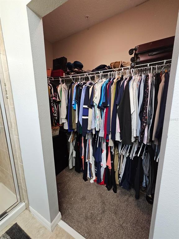 8552 Powder Ridge Trail Windermere, FL 34786 - Photo 23 of 30 a view of walk in closet with clothes