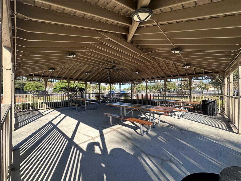 8552 Powder Ridge Trail Windermere, FL 34786 - Photo 24 of 30 a view of a patio with table and chairs under an umbrella with a barbeque