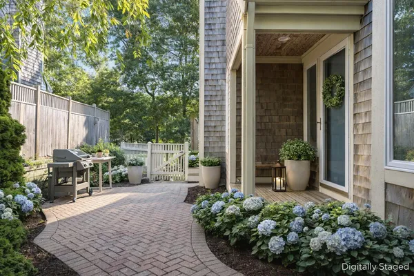 a view of backyard with outdoor seating and plants