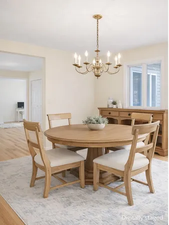 a kitchen with a dining table chairs and refrigerator