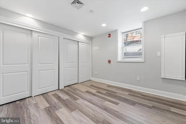 a view of empty room with wooden floor
