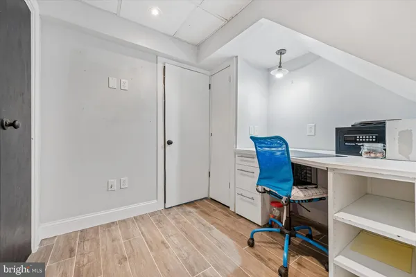 a view of a workspace with furniture and wooden floor
