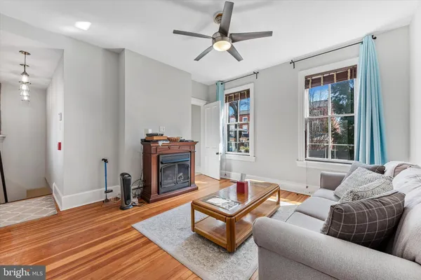 a living room with furniture a fireplace and a window