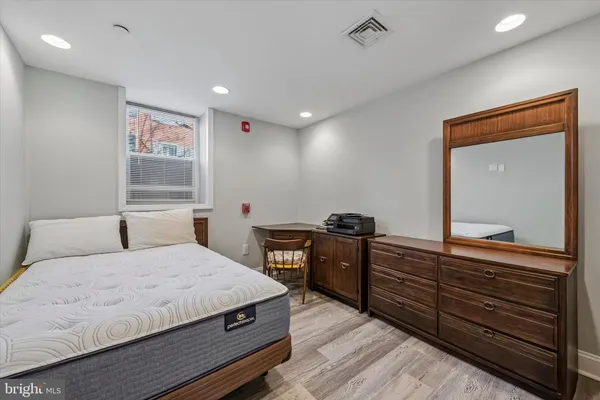 a bedroom with a bed and a dresser