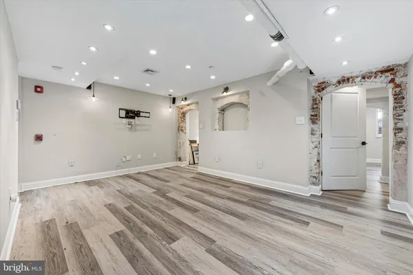 a view of empty room with wooden floor