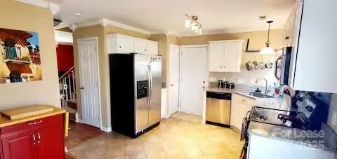 a view of a kitchen with refrigerator and cabinets