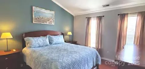 a large bed sitting in a bedroom next to a window