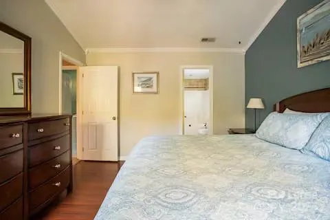 a bedroom with a bed and a dresser in it