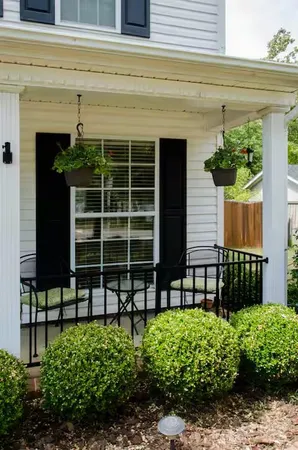 a front view of a house with a garden