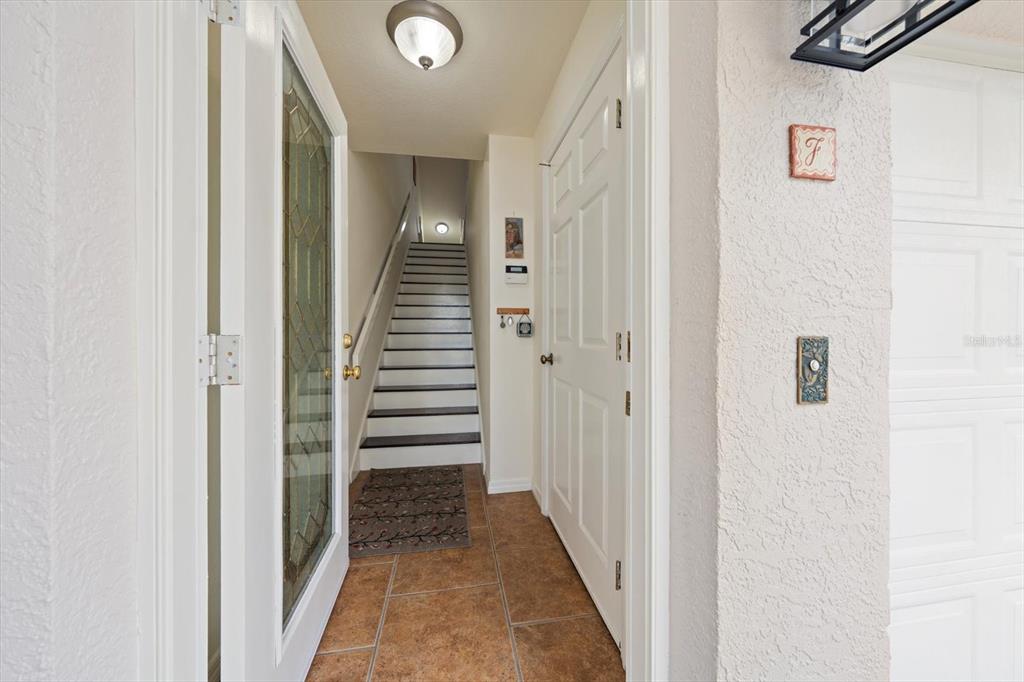 1206 Gulf Boulevard, Unit A6 Indian Rocks Beach, FL 33785 - Photo 3 of 61 a view of a hallway with wooden floor and entryway