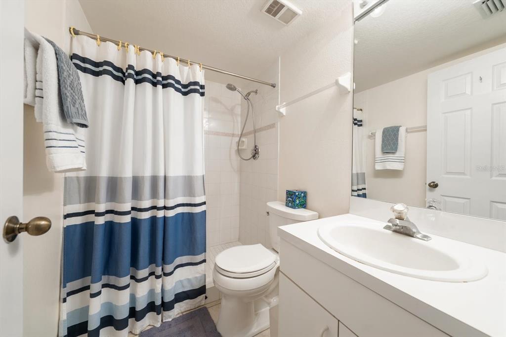 1206 Gulf Boulevard, Unit A6 Indian Rocks Beach, FL 33785 - Photo 39 of 61 a bathroom with a sink toilet and shower