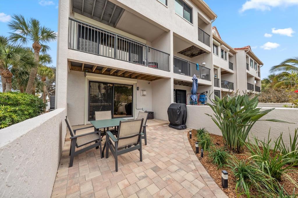 1206 Gulf Boulevard, Unit A6 Indian Rocks Beach, FL 33785 - Photo 46 of 61 a view of a building with a table and chairs