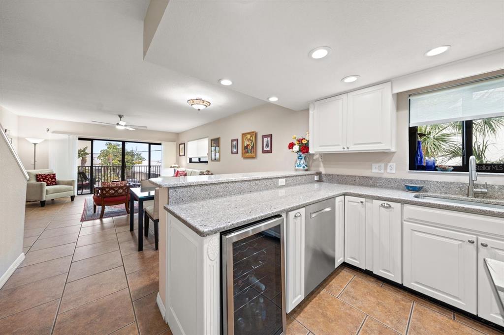 1206 Gulf Boulevard, Unit A6 Indian Rocks Beach, FL 33785 - Photo 10 of 61 a kitchen with lots of counter top space sink and center island