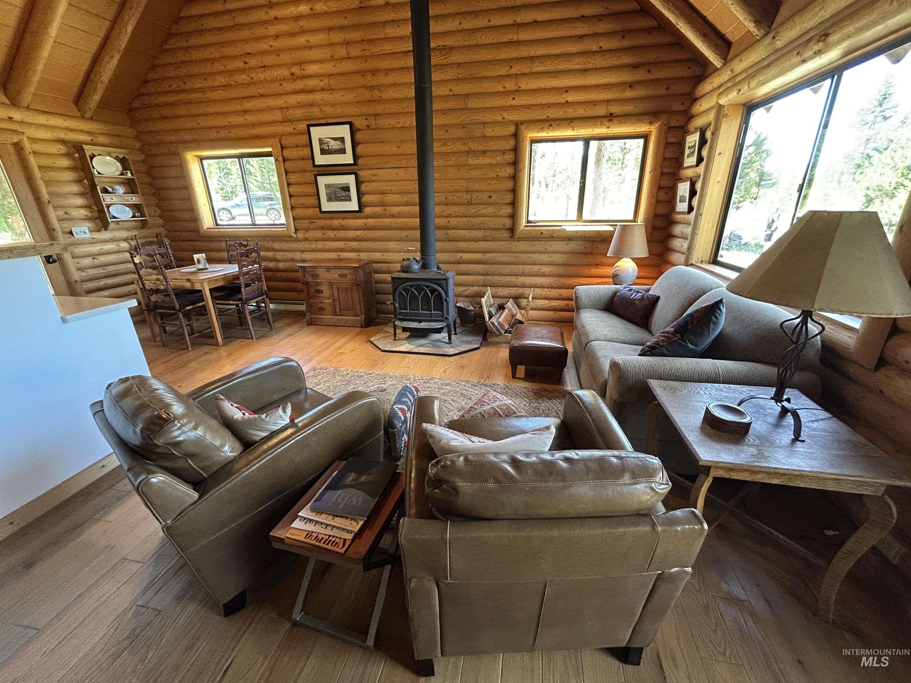 35 Sawtooth Way Stanley, ID 83278 - Photo 16 of 36 Log-style interior featuring high-vaulted ceilings and expansive wood-finish flooring
