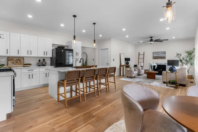 a large kitchen with cabinets table and chairs