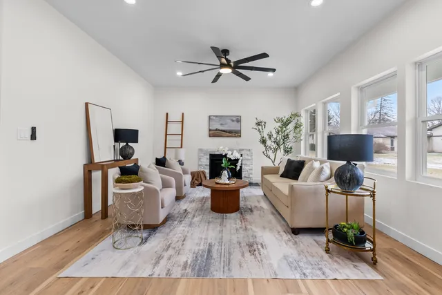 a living room with furniture a flat screen tv and a fireplace