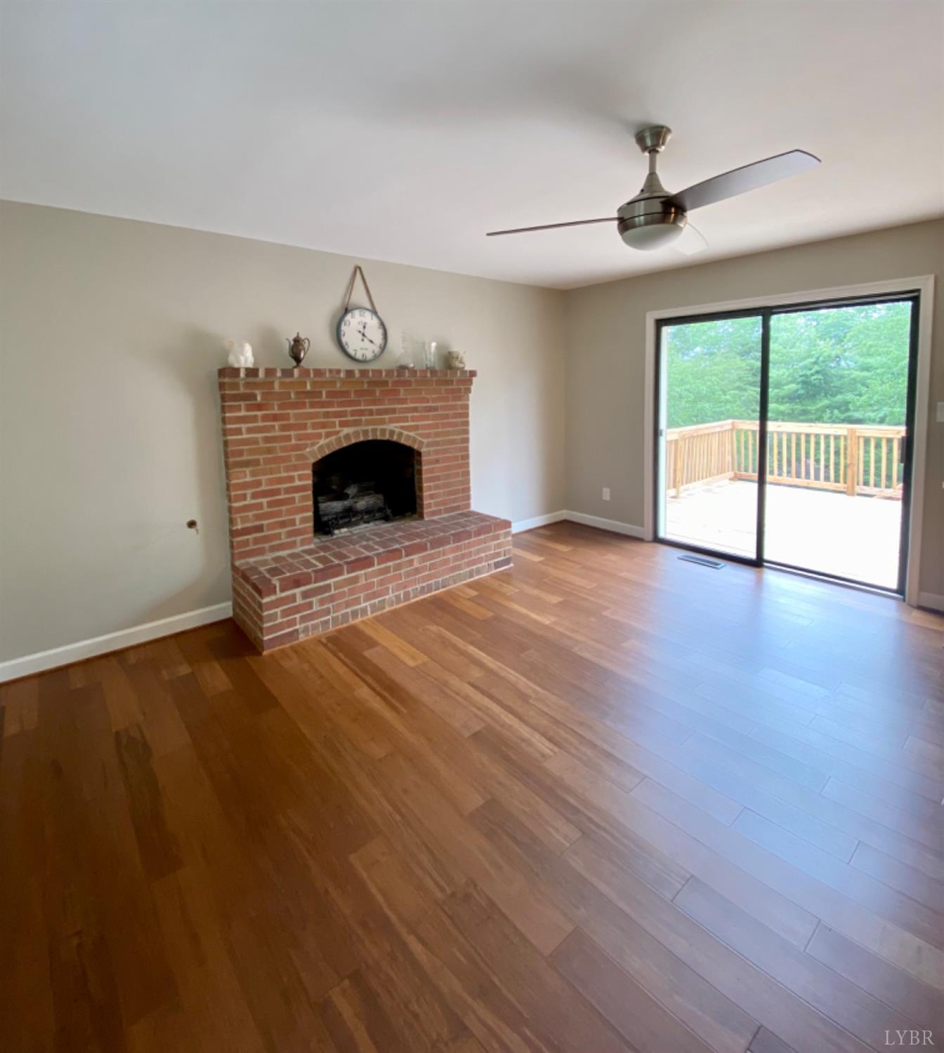 378 Sunnymeade Road Rustburg, VA 24588 - Photo 5 of 44 a view of an empty room with a fireplace and a window
