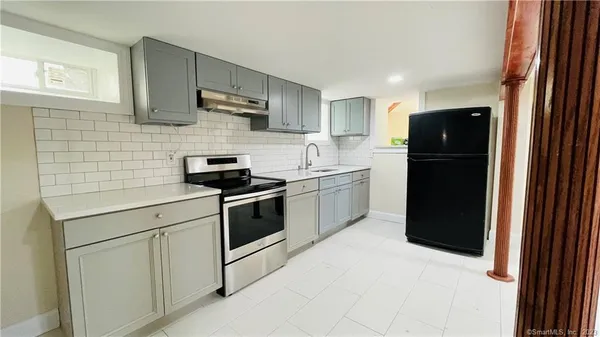 a kitchen with a sink and a refrigerator