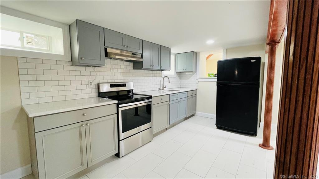 31 Brainerd Road Branford, CT 06405 - Photo 2 of 15 a kitchen with a sink and a refrigerator