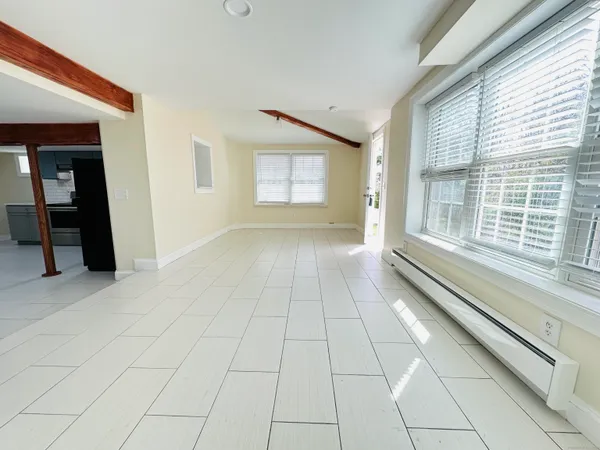 a view of an empty room and a window