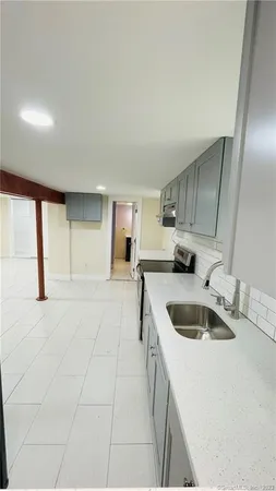 a kitchen with a sink cabinets and a kitchen island
