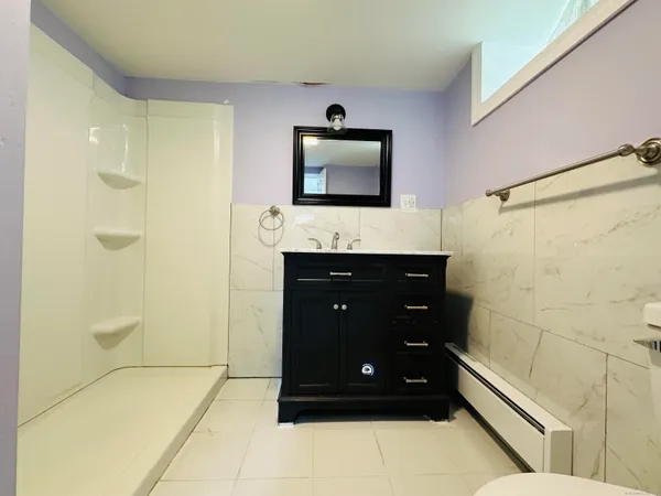 a bathroom with a sink a shower and a mirror