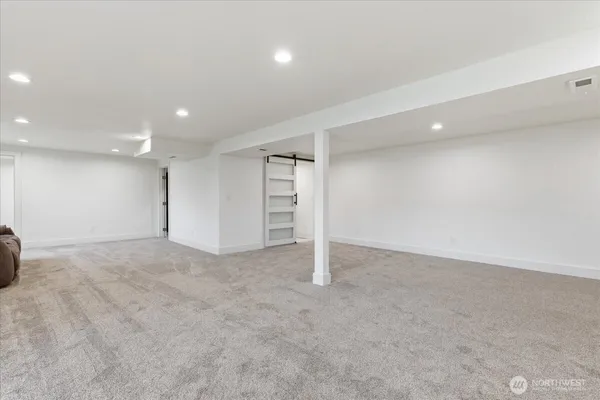 an empty room with a projector and a window