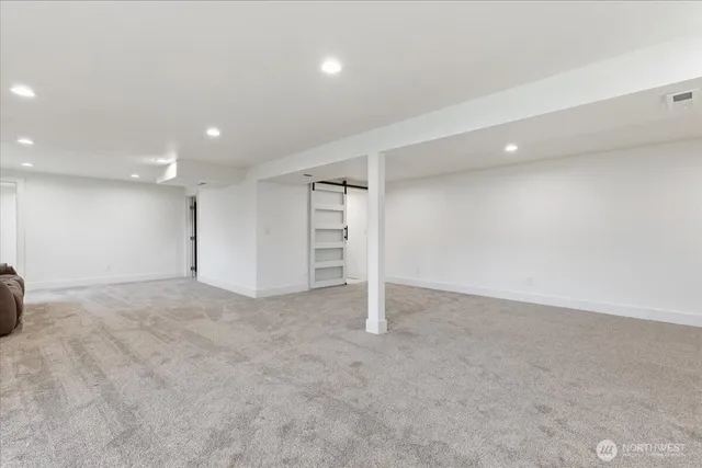 an aerial view of a house with a yard and ocean view